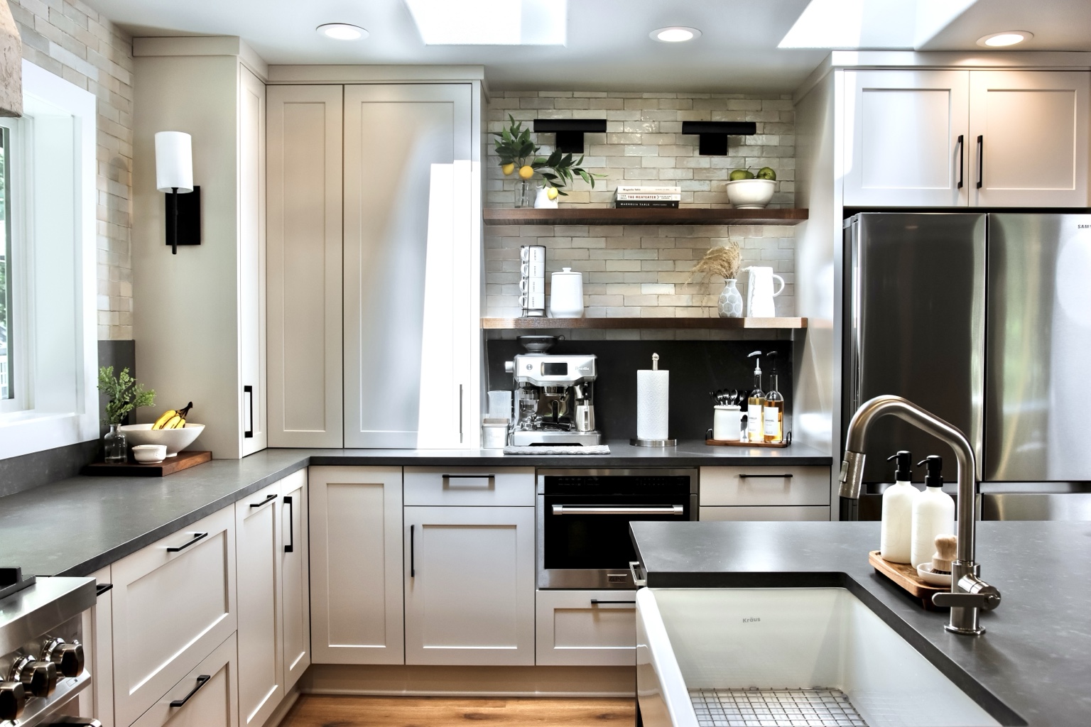 Open wood shelves and a coffee station in the light kitchen